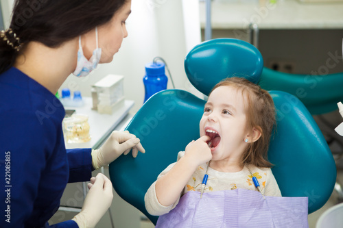 Child at dentist office sits in comforatble chair