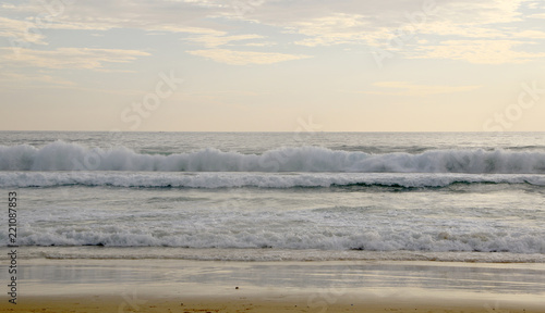 Beautiful sunset on Karon beach. The surf pounds the shore. Phuket, Thailand