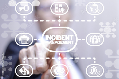 Businessman clicks a incident management words button on a virtual structural panel. Incident Management Business Finance Technology concept. photo