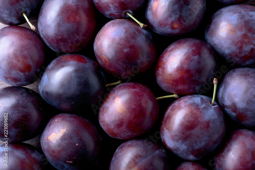Ripe juicy plums as background.
