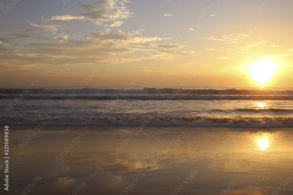 Beautiful sunset on Karon beach. The surf pounds the shore. Phuket, Thailand