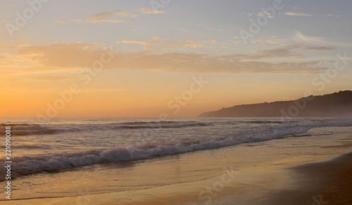 Beautiful sunset on Karon beach. The surf pounds the shore. Phuket, Thailand