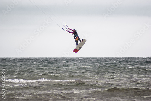 Kitesurfing. Athlete jumping out of the water
