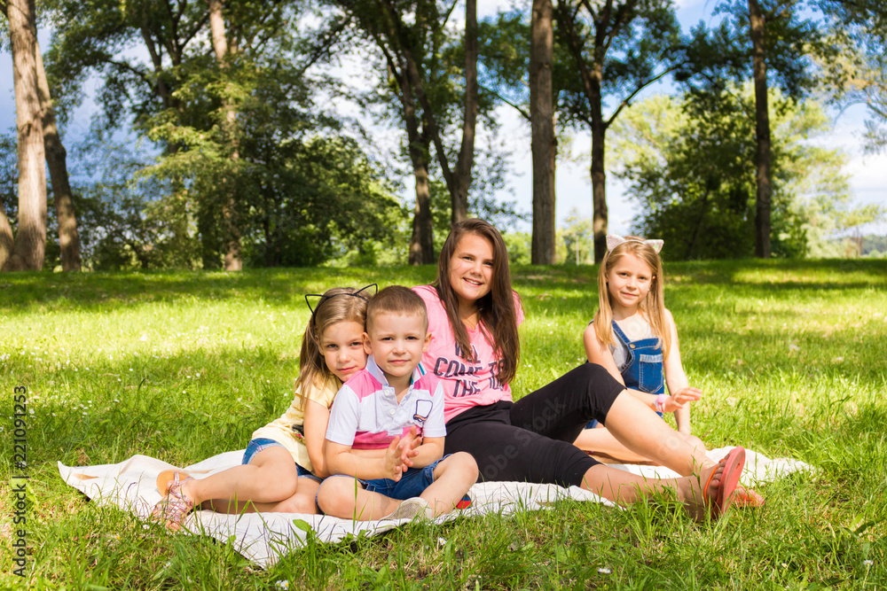 Portrait of four siblings in the park. Portrait of four siblings in the park.
