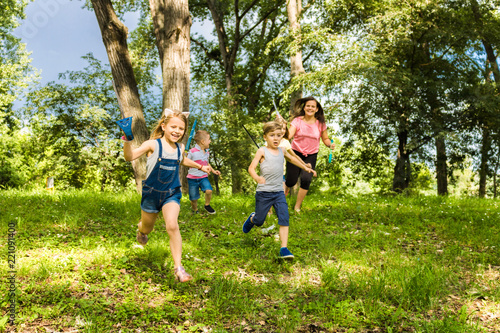 Happy kids running in the forest.