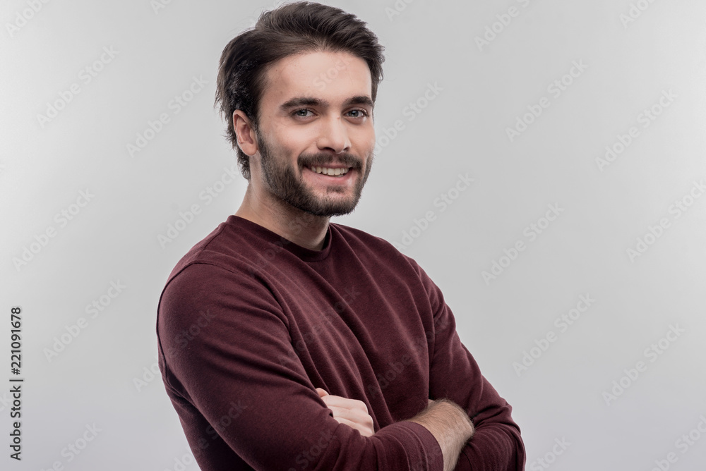 Handsome man. Image without face retouching with handsome bearded smiling man wearing plain dark red shirt Handsome man. Image without face retouching with handsome bearded smiling man wearing plain dark red shirt