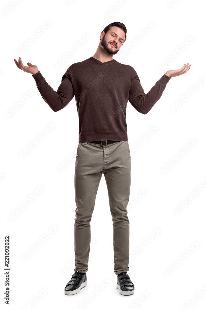 A bearded man in casual clothes stands with both arms up and a questioning face expression. A bearded man in casual clothes stands with both arms up and a questioning face expression.