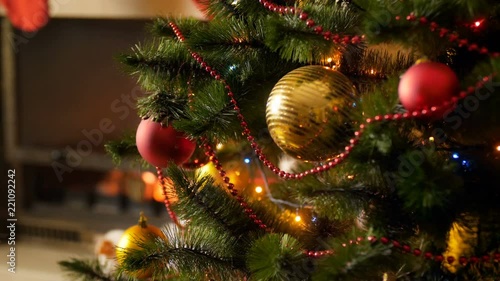 Wallpaper Mural Closeup 4k footage of beautiful golden and red baubles hanging on Christmas tree decoraetd with glowing colorful lights and garlands. Perfect background for winter celebrations and holidays Torontodigital.ca