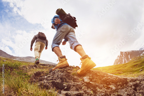 Obraz na plátně Trekking concept two tourists walking mountains