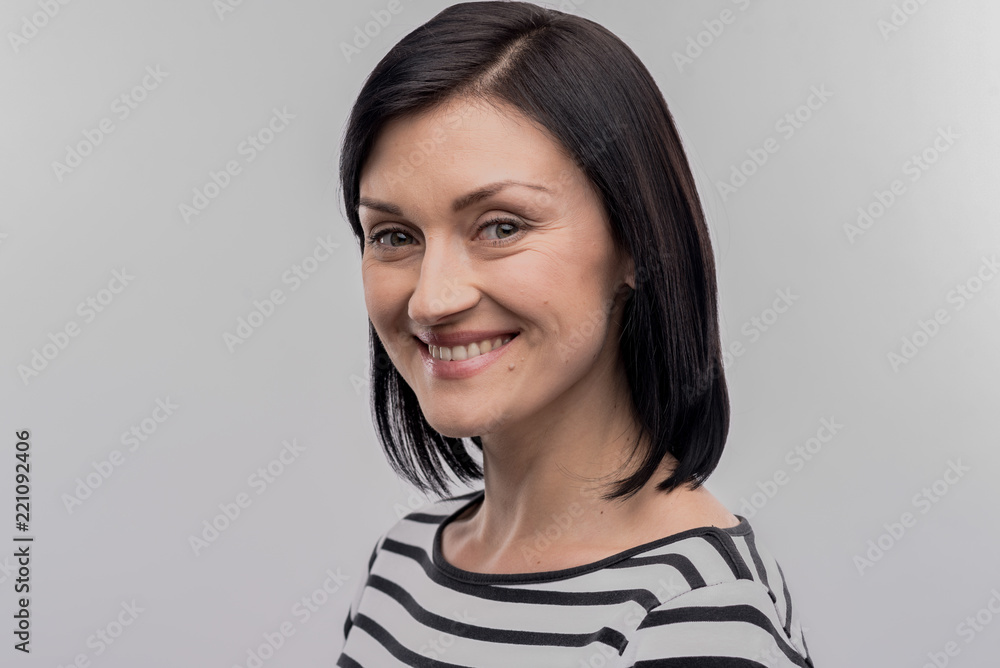 Appealing woman. Image without face retouching with green-eyed appealing woman wearing striped black and white shirt Appealing woman. Image without face retouching with green-eyed appealing woman wearing striped black and white shirt