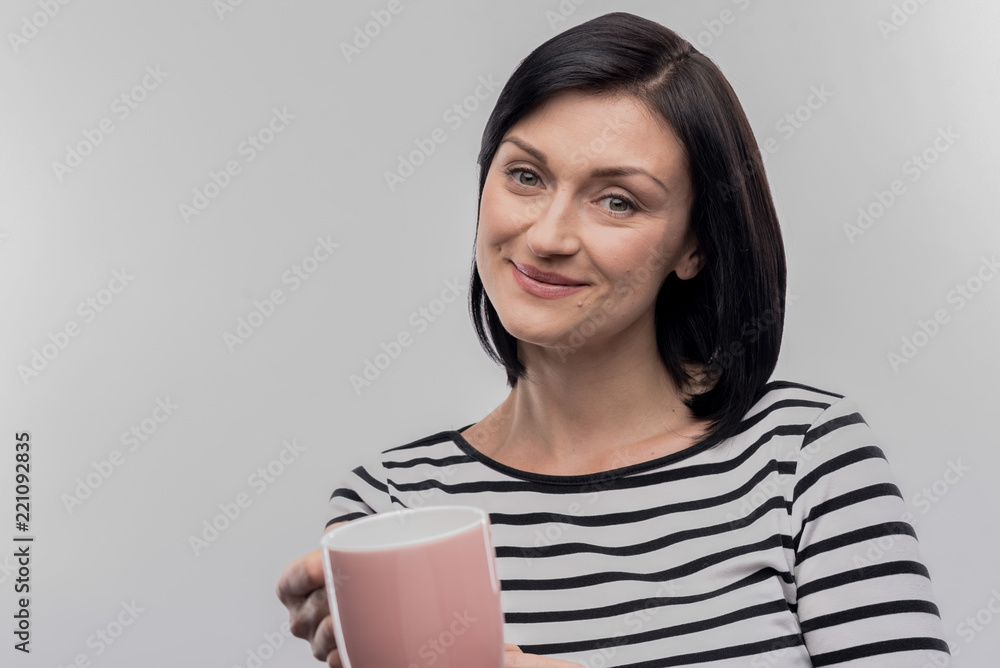 Cup of tea. Caring dark-haired wife offering cup of tea her loving husband on image without face retouching Cup of tea. Caring dark-haired wife offering cup of tea her loving husband on image without face retouching