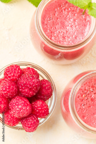 Raspberry smoothie close up photography with fresh summer blended cocktail and ripe berries.