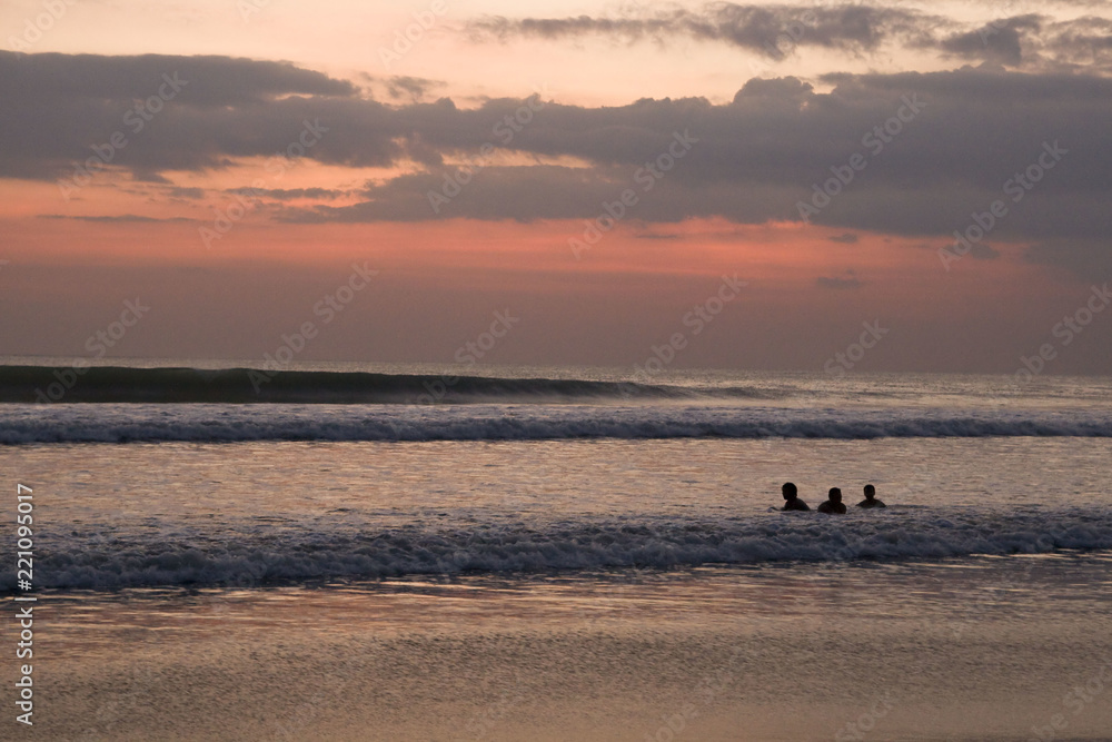People swimming in waving water in Indonesia People swimming in waving water in Indonesia