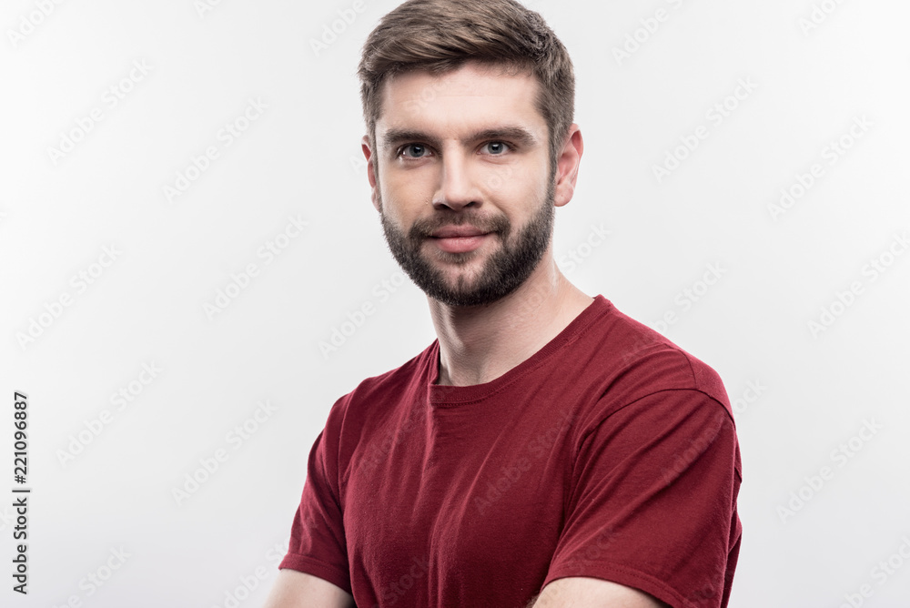 Handsome man. Image without face retouching with bearded dark-haired handsome man wearing dark red shirt Handsome man. Image without face retouching with bearded dark-haired handsome man wearing dark red shirt