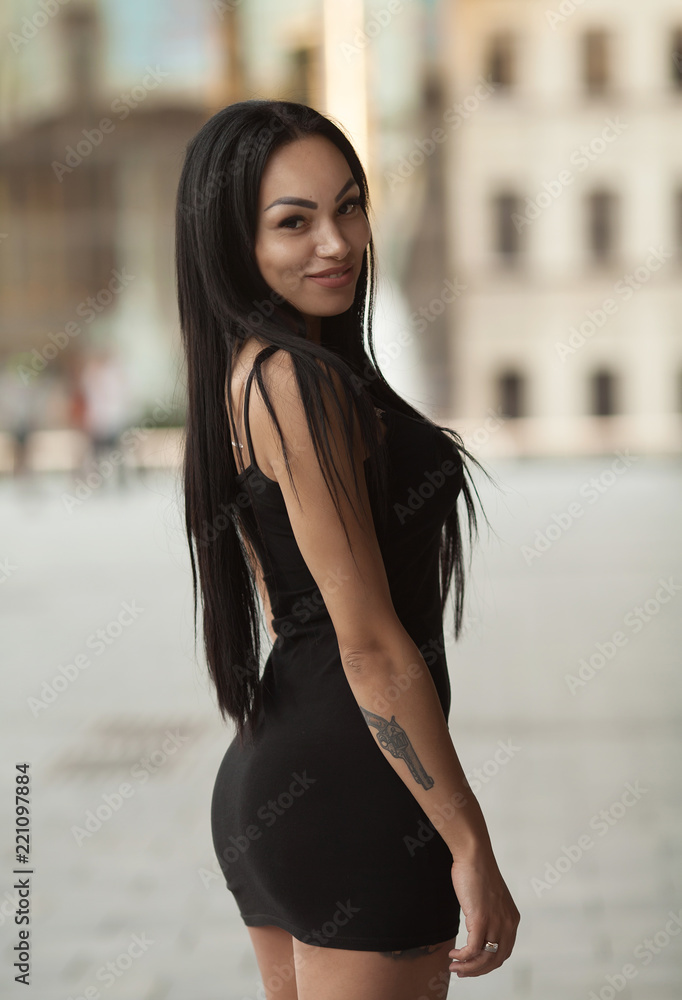 A portrait of a beautiful sexy asian woman smiling brightly at the camera