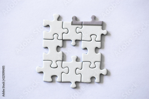 Piece of a puzzle missing on a white background