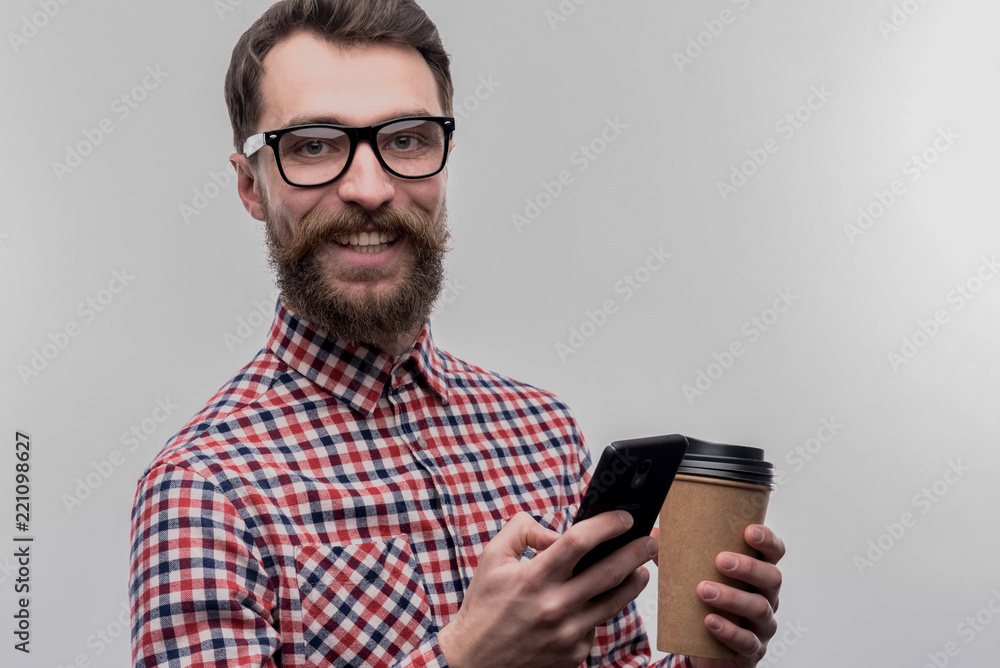 Hard-working businessman. Image without face retouching with busy hard-working businessman wearing glasses holding takeaway coffee Hard-working businessman. Image without face retouching with busy hard-working businessman wearing glasses holding takeaway coffee