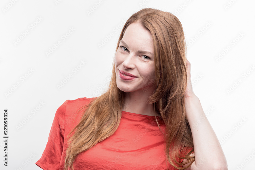 Appealing woman. Beaming appealing woman wearing bright red shirt feeling excited on image without face retouching Appealing woman. Beaming appealing woman wearing bright red shirt feeling excited on image without face retouching
