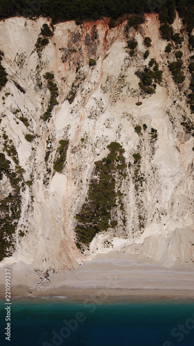 Aerial bird's eye view photo taken by drone of tropical white sandy beach with turquoise clear waters and pine trees