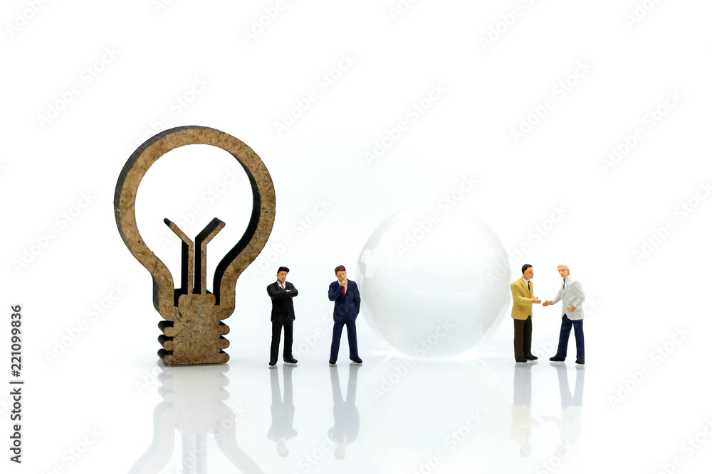 Miniature people : Businessman with jigsaw and idea lamp using for concept of swap idea day. Miniature people : Businessman with jigsaw and idea lamp using for concept of swap idea day.