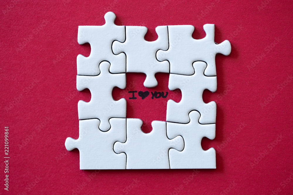 Fototapeta premium I love you under a missing piece of a puzzle on red background