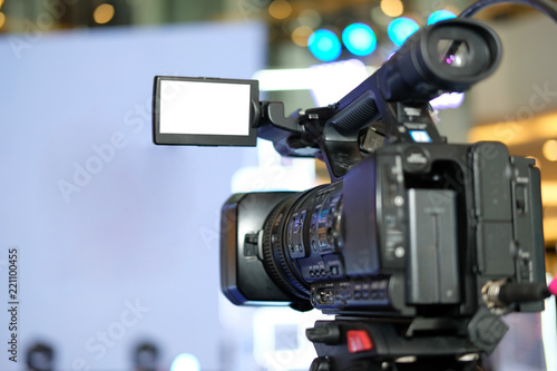 video production camera recording live event on stage. television social media broadcasting seminar conference