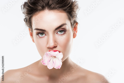beautiful nude woman holding pink flower in lips  isolated on white