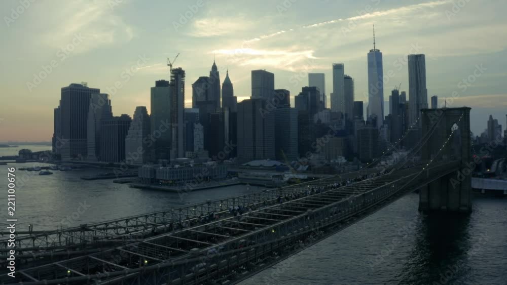 alt dusk view of downtown Manhattan flying bkwd alongside Bkln Bridge alt dusk view of downtown Manhattan flying bkwd alongside Bkln Bridge