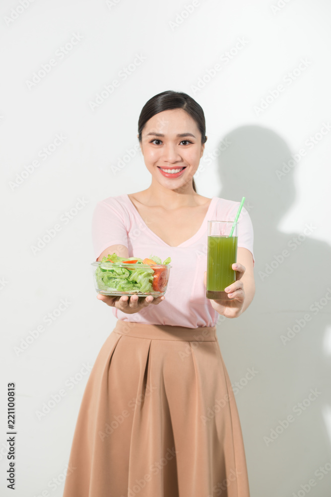 Woman with green detox smoothies, salad in glass bowl isolated on white background. Proper nutrition, vegetarian food, healthy lifestyle, dieting concept. Area to copy space Woman with green detox smoothies, salad in glass bowl isolated on white background. Proper nutrition, vegetarian food, healthy lifestyle, dieting concept. Area to copy space