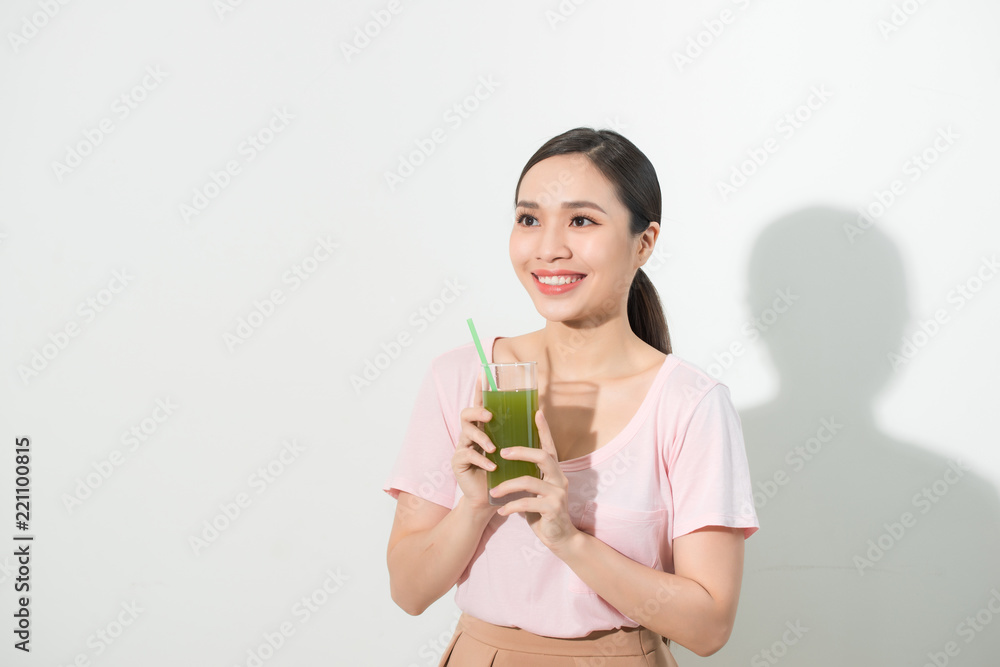 Go green. Young beautiful woman enjoying a healthy raw fruit vegetable juice. Studio shot. Go green. Young beautiful woman enjoying a healthy raw fruit vegetable juice. Studio shot.