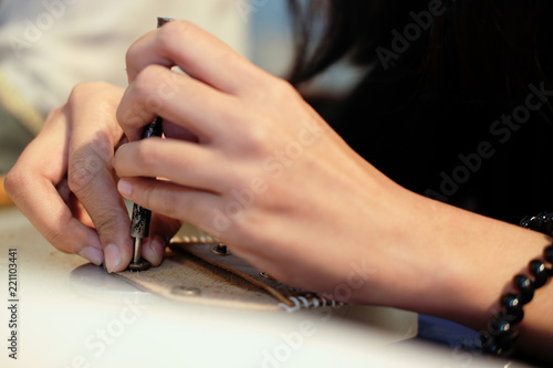 craftsman pinching button on leather bag. handmade DIY handicraft