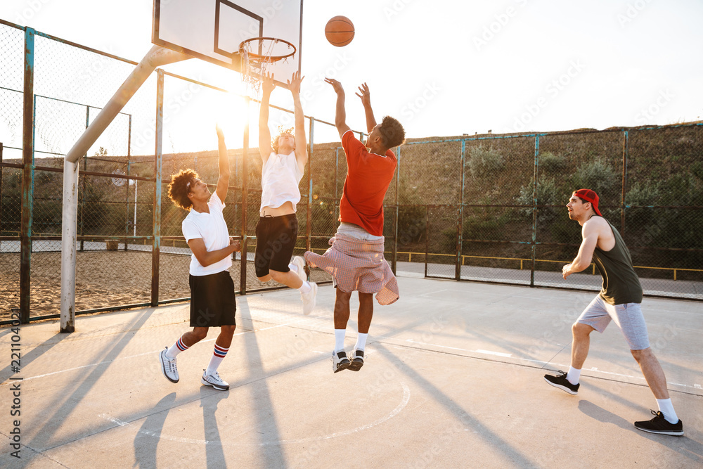Group of young sporty multiethnic men basketball players