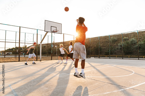 Group of young cheerful multiethnic men basketball © Drobot Dean