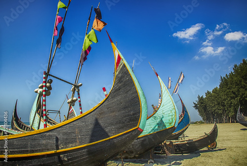 Wooden Fishing Boat On a Coxbazar Sea Beach With Blue Sky Background in Bangladesh photo