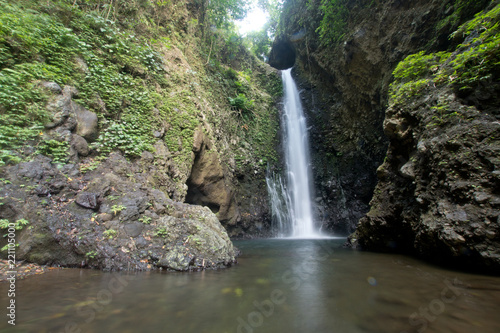 Waterfall in green rainforest. Triple waterfall Sekumpul in the mountain jungle. Bali Indonesia. Travel concept.