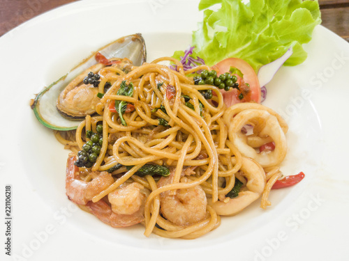 Spaghetti with spicy mixed seafood on a white plate