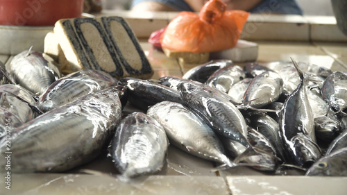 Fresh fish in Asian market. Sale of fresh sea fish in the Asian public store. Sea fish lying on the shopboard at one of the street markets. Philippines. photo