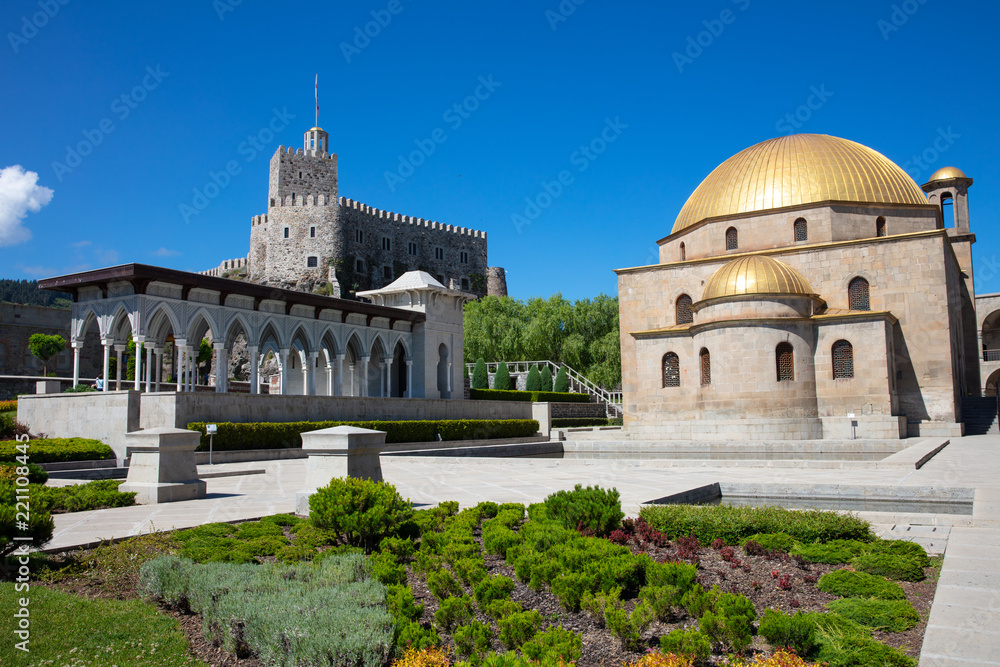 Fortress Rabat in Georgia. Mosque with gold dome, gallery of Moorish and garden in sunny day