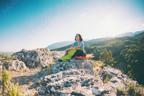 A woman is sitting in a sleeping bag.