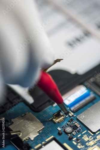 man hands, working on a electronic device, welding