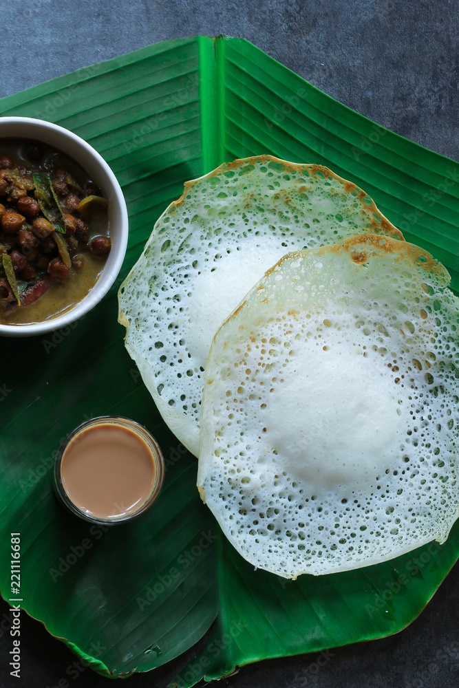 Palappam/ Paalappam - Kerala Appam with Kadala Curry tea on banana leaf ...