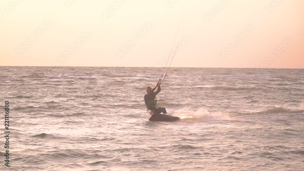 A man tries to do a trick on a kite surf and falls into the water, bit slow motion A man tries to do a trick on a kite surf and falls into the water, bit slow motion