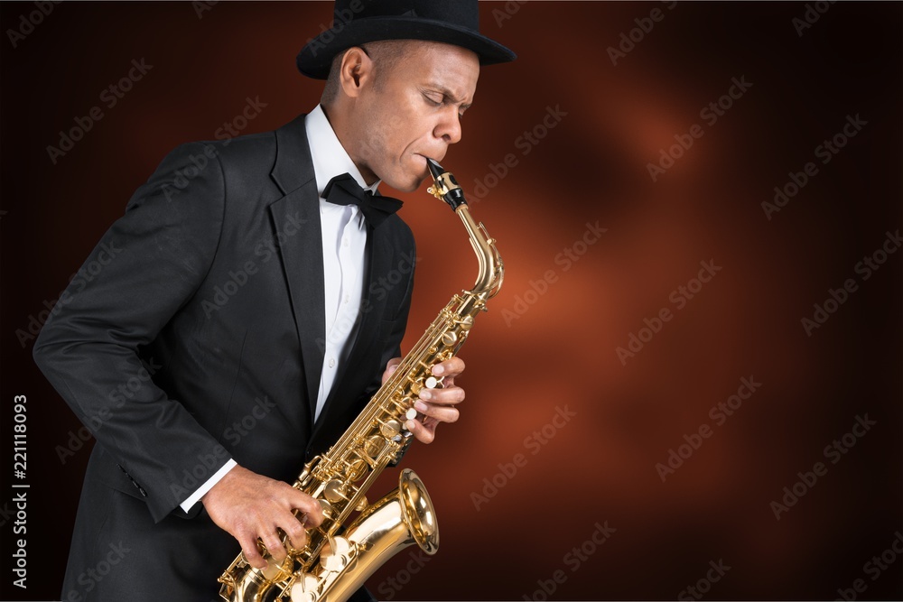 Fototapeta premium Close-up man playing on saxophone on white background