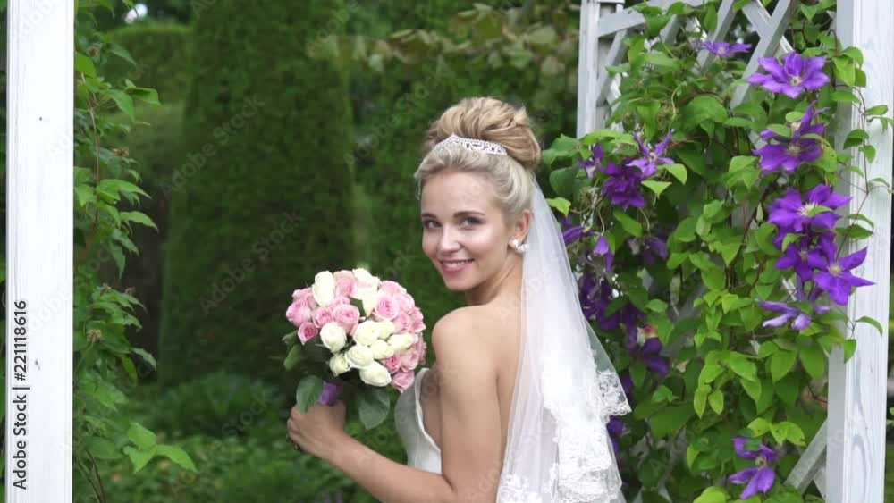 beautiful image of the bride with a bouquet of flowers in a beautiful garden beautiful image of the bride with a bouquet of flowers in a beautiful garden