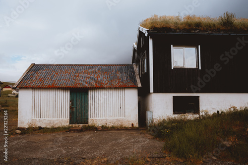 Grungy houses with grass on roof