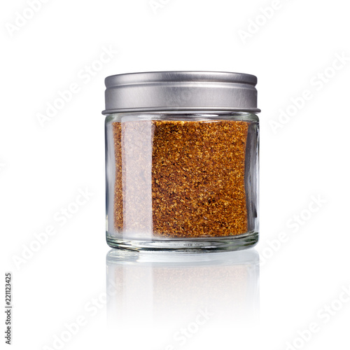 cayenne pepper in a glas with metal lid, isolated on white