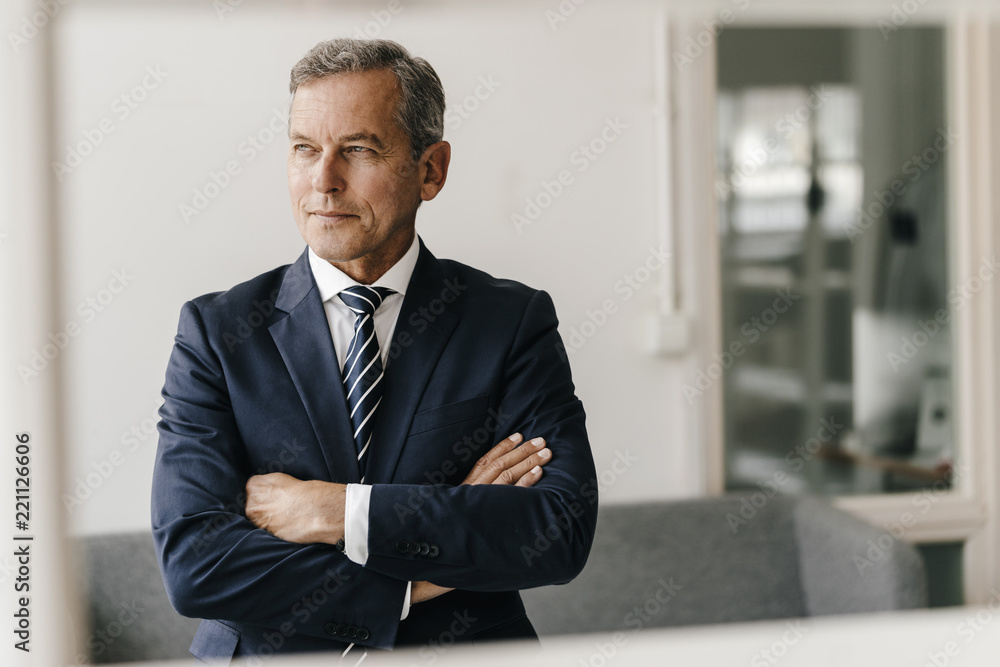 Portrait of mature businessman with arms crossed in his office Portrait of mature businessman with arms crossed in his office