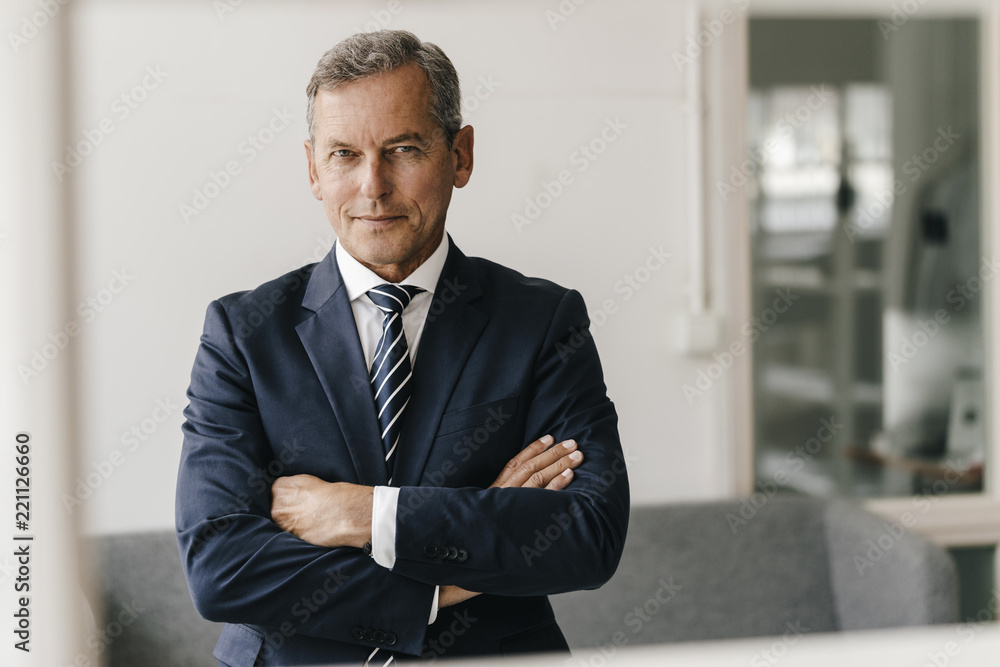 Portrait of mature businessman with arms crossed in his office Portrait of mature businessman with arms crossed in his office
