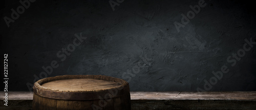 Oktoberfest beer barrel and beer glasses with wheat and hops on wooden table