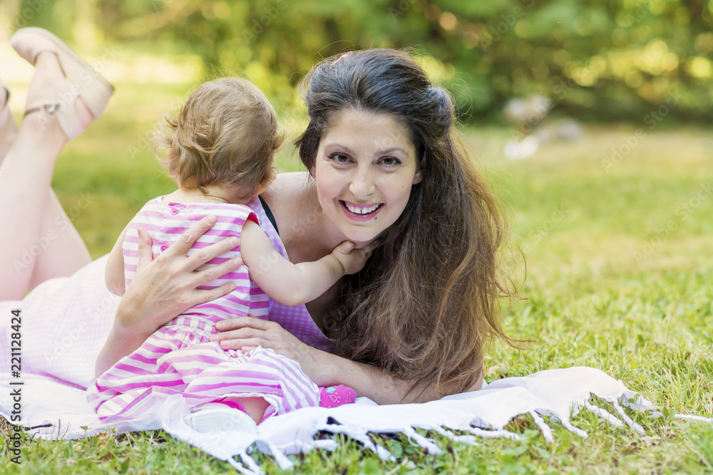 Happy Mother with her Baby Girl in the Summer Park .Mother and Daughter .Happy Family, Mother with Little Child Happy Mother with her Baby Girl in the Summer Park .Mother and Daughter .Happy Family, Mother with Little Child